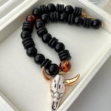 Black bead necklace with horn pendant