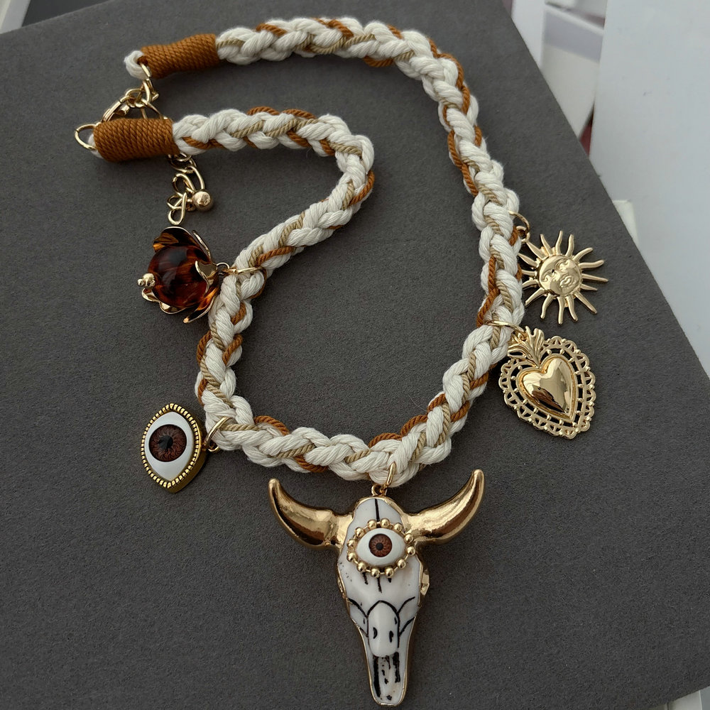 White cord necklace with horn charm