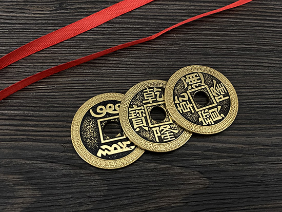 3 chinese coins with red ribbon meaning