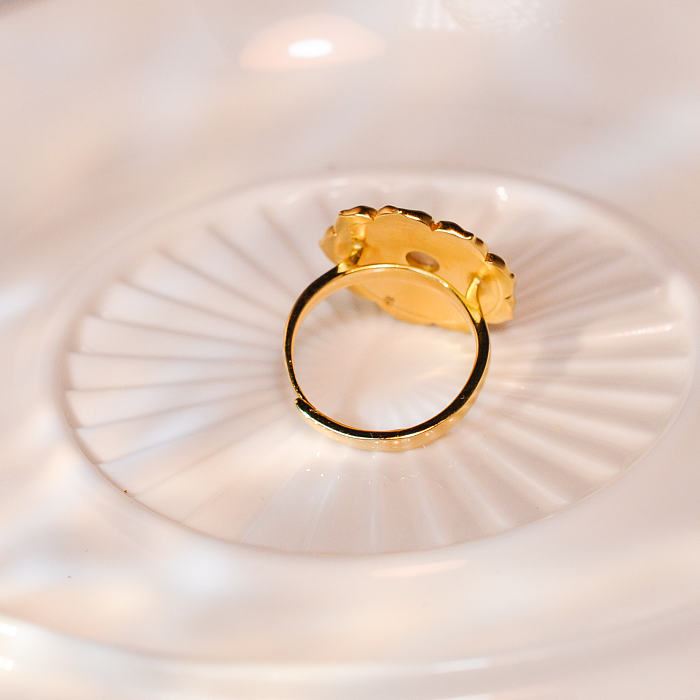 Handcrafted Lotus - Silk Road - Mother of Pearl - Luxury Sterling Silver Ring showcasing a delicate lotus design with a luminous pearl at the center, set against a textured, gold-plated sterling silver backdrop