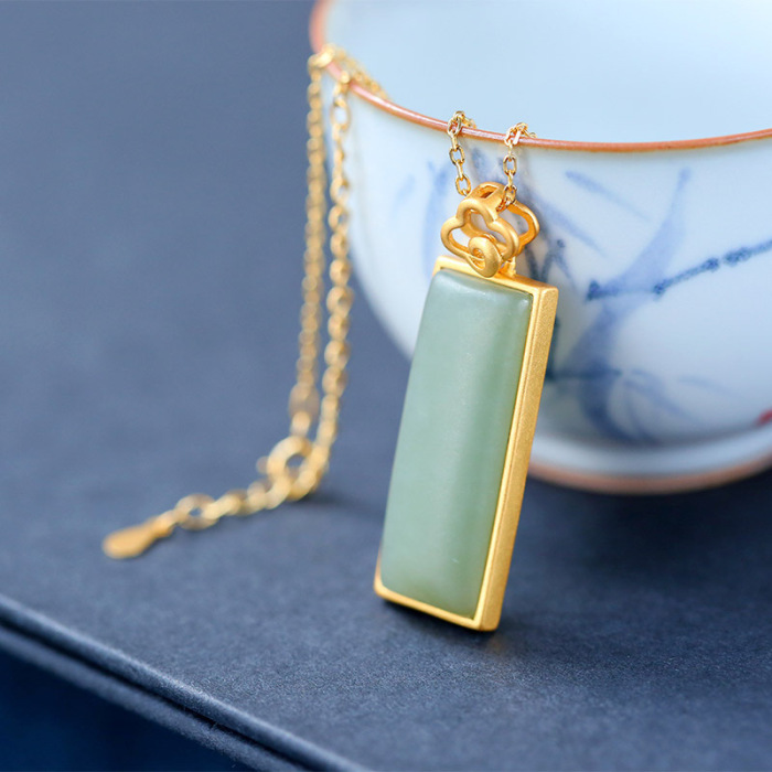 Close-up of the light blue rectangle Qiemo jade pendant in gold sterling silver frame