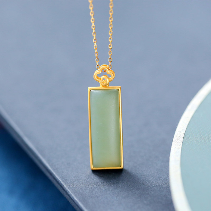 Close-up of the light blue rectangle Qiemo jade pendant in gold sterling silver frame