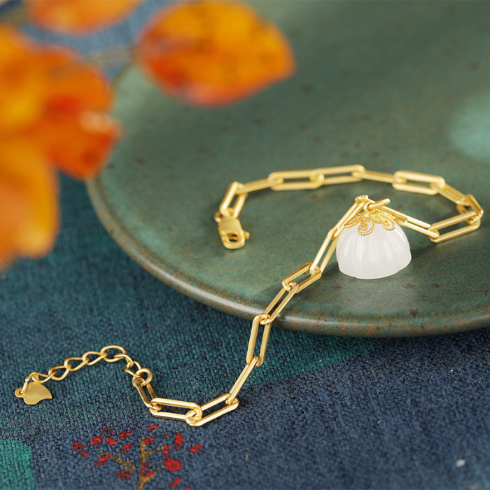 Gold bracelet with lotus pod charm