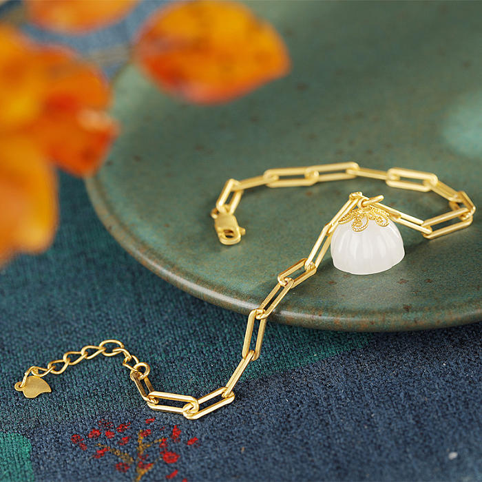 Gold bracelet with lotus pod charm