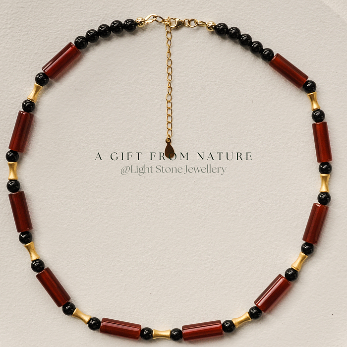 Dawn Sun designer handmade stone necklace featuring red and black agate beads