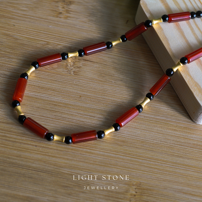 Dawn Sun designer handmade stone necklace featuring red and black agate beads