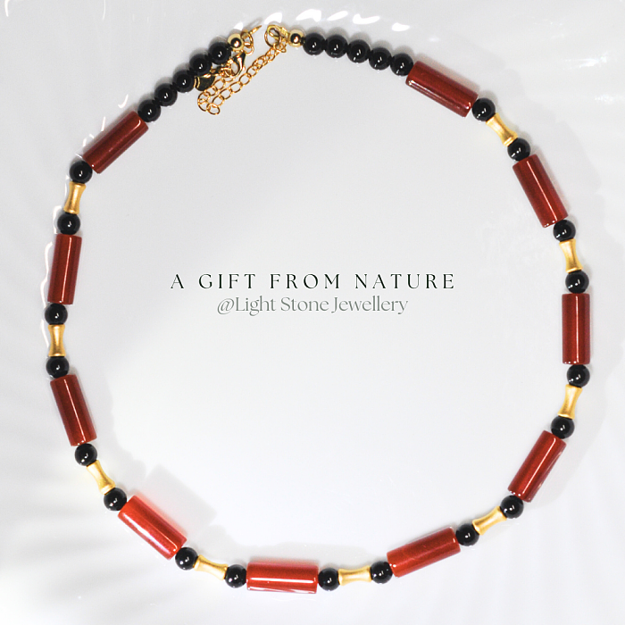 Dawn Sun designer handmade stone necklace featuring red and black agate beads