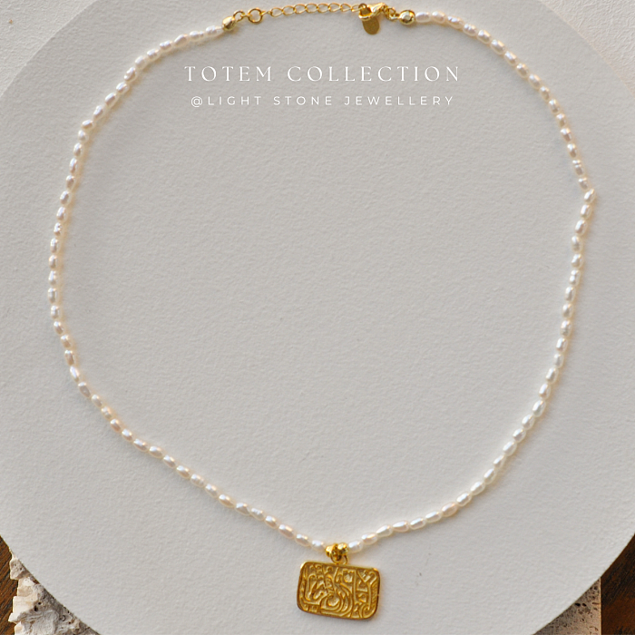 Elegant Pearl Strand with Golden Phoenix Totem Pendant in Totem Collection