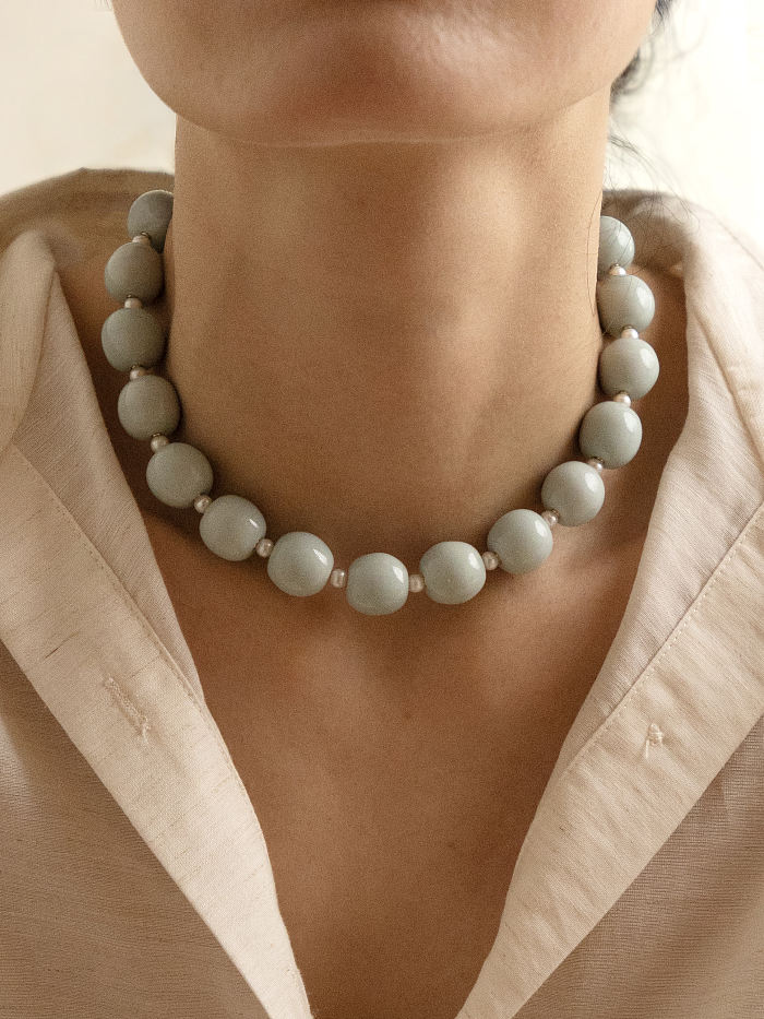 Close-up of model wearing the porcelain choker, highlighting the bold round beads and snug collar fit.
