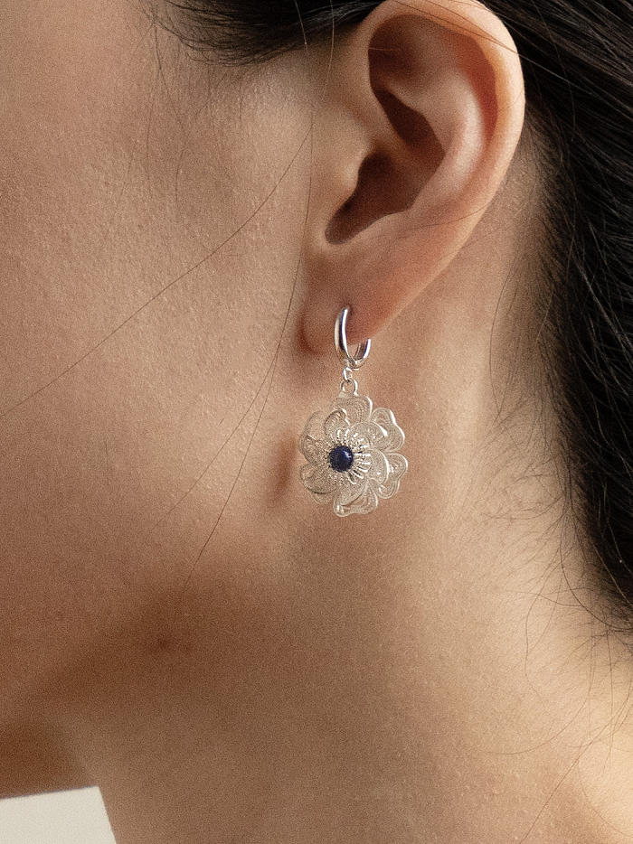 Close-up of hinged hoop worn just below the ear, emphasizing compact proportion and soft fall