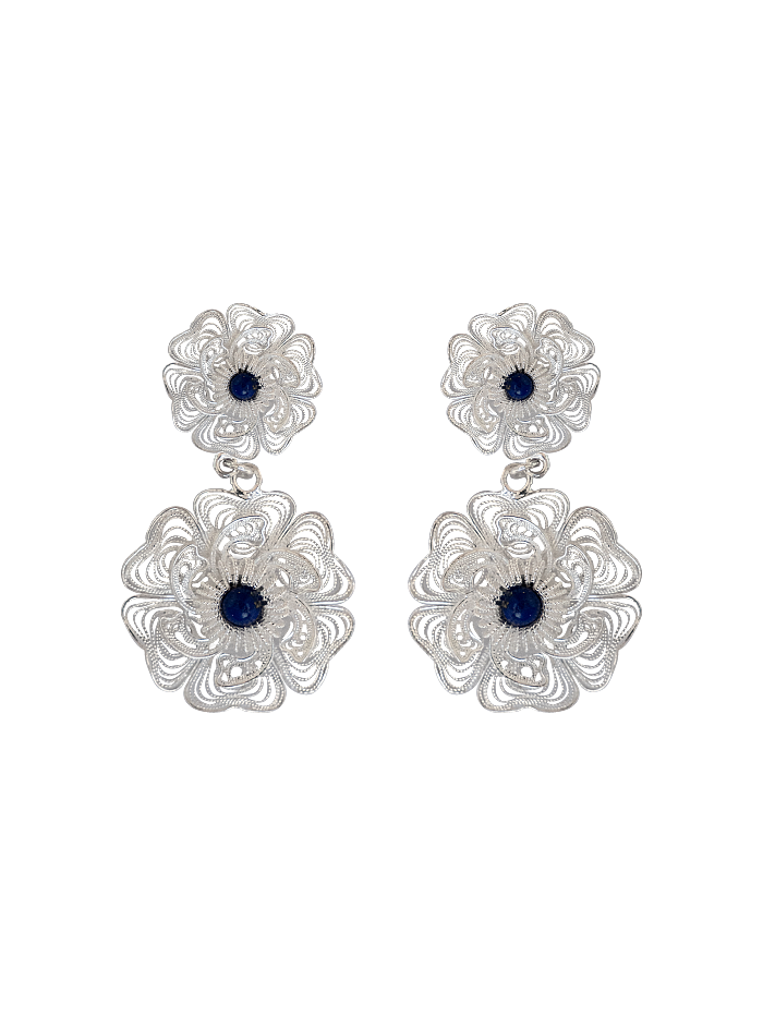 Studio shot of twin-flower silver filigree earrings with lapis lazuli centers on neutral background