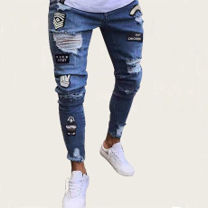 Distressed badge jeans