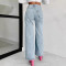 Women's washed denim jeans with multiple pockets and hand drilled opening