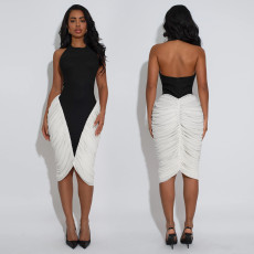Fashionable women's dress with a hanging neck, exposed back, and folded buttocks